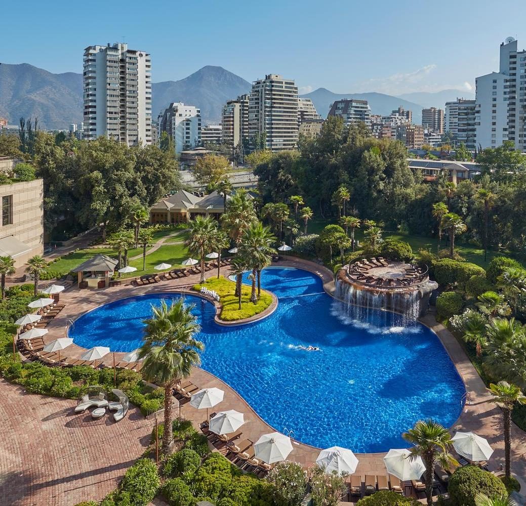 Gardens and pool of the hotel in Santiago, with the Andes behind