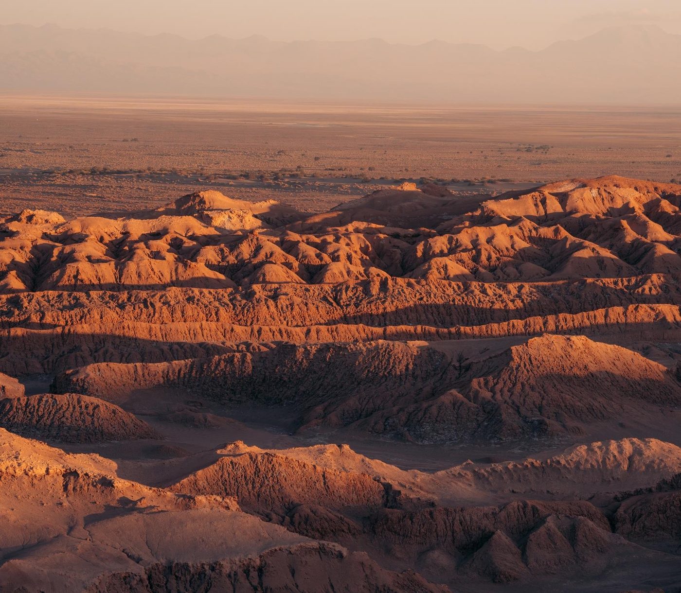 Rock ridges of the Atacama Desert turned orange at sunset