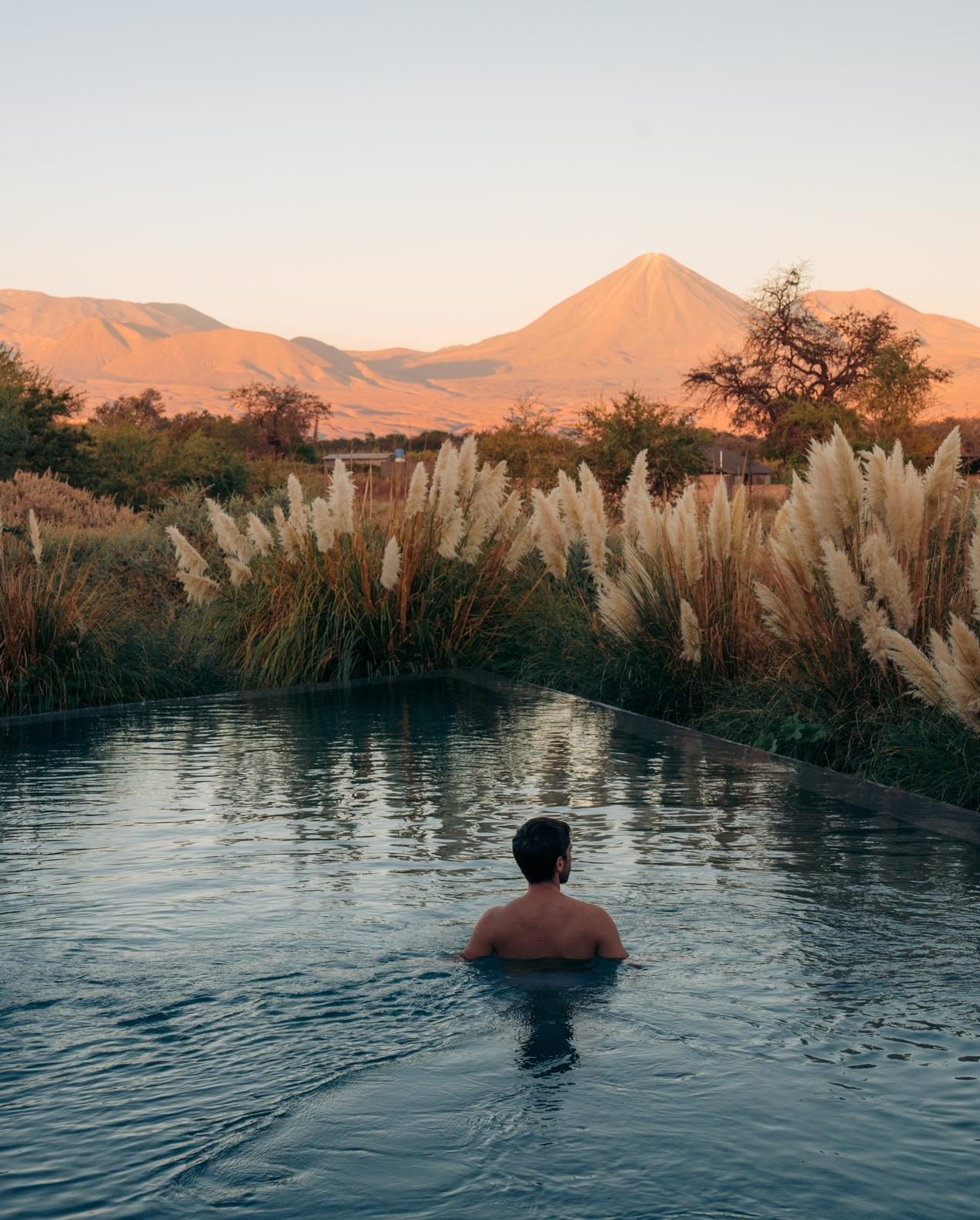 A pool facing the Licancabur volcano lit by the first light of day