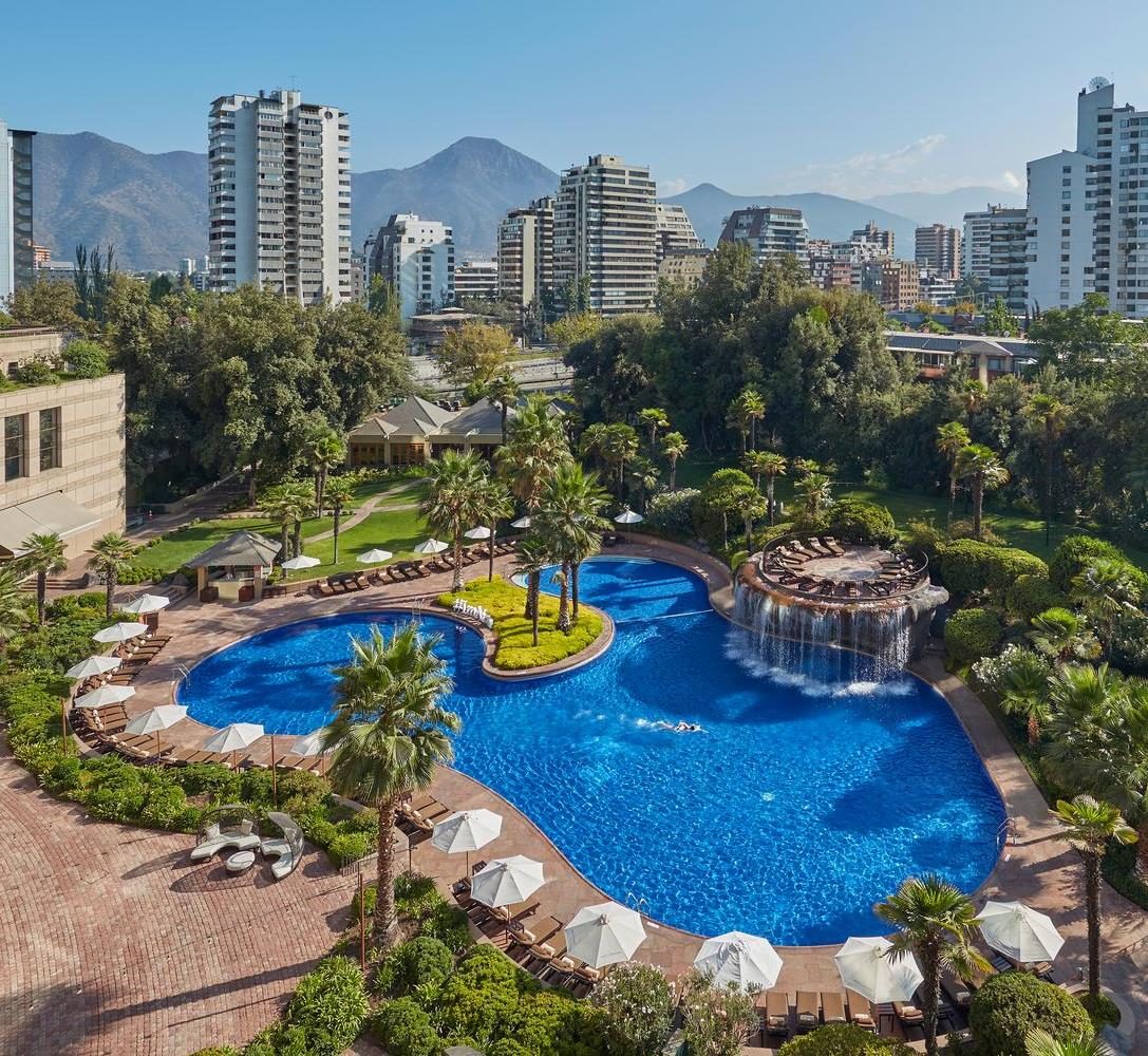 Gardens and pool of the hotel in Santiago, with the Andes behind