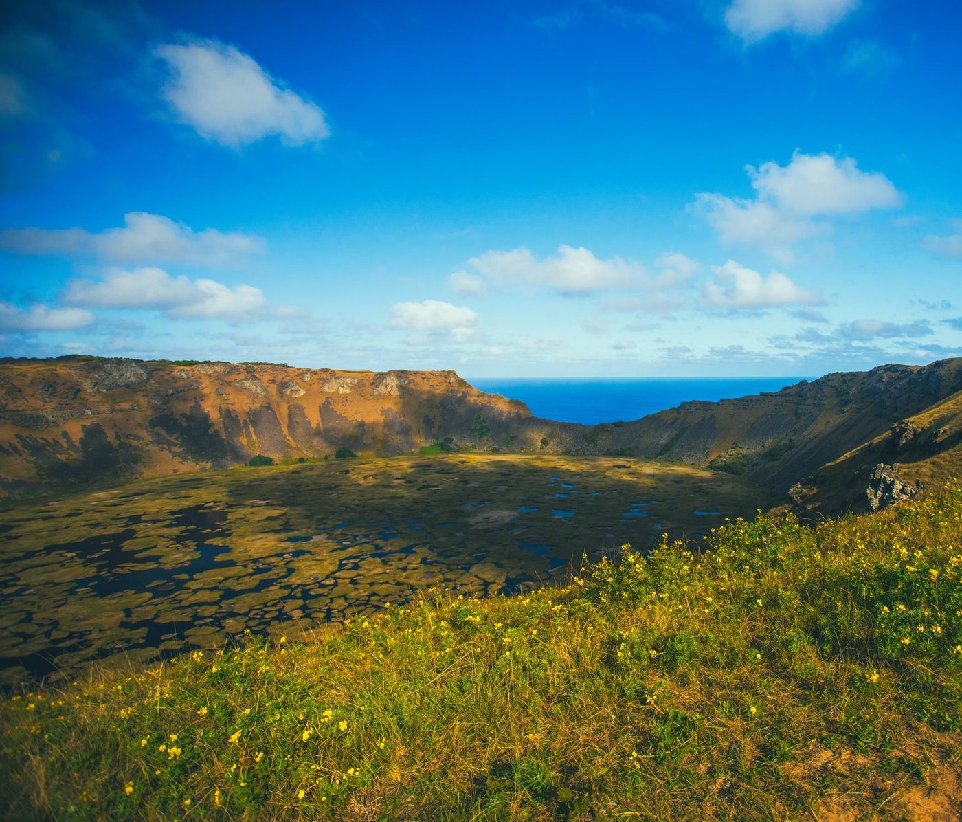 The crater of the Rano Kau volcano with its inner lake and the ocean beyond
