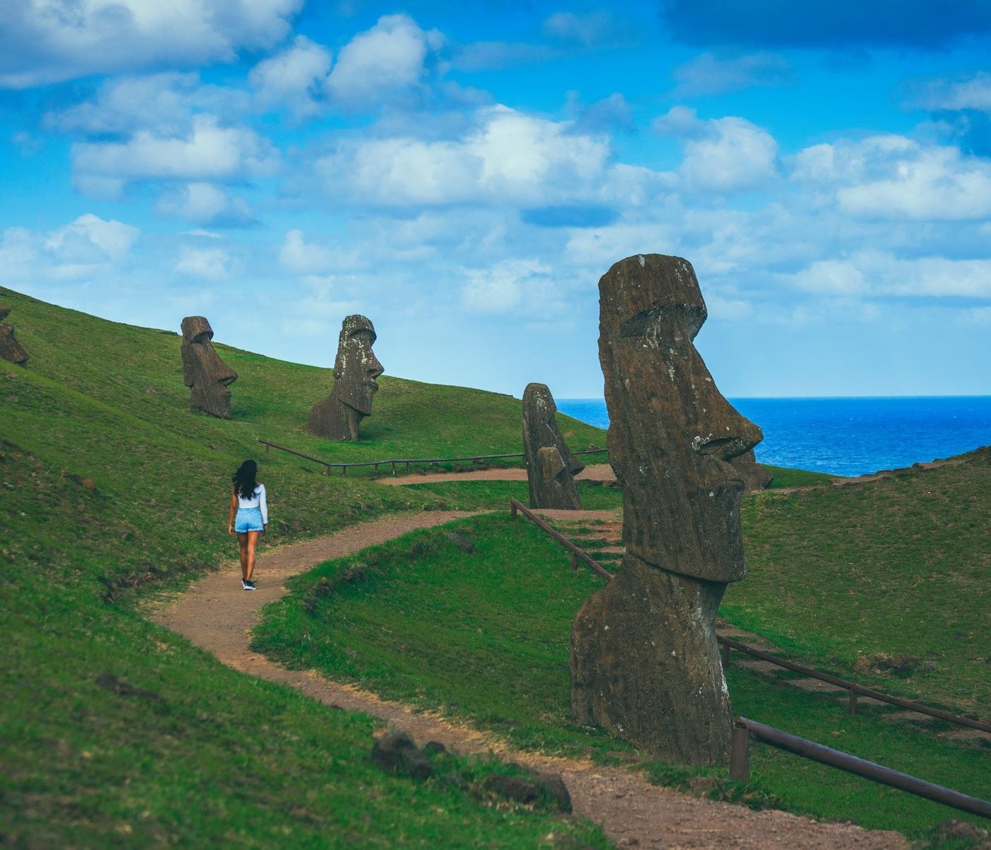 A path among the moai on the slope of Rano Raraku, with the ocean beyond