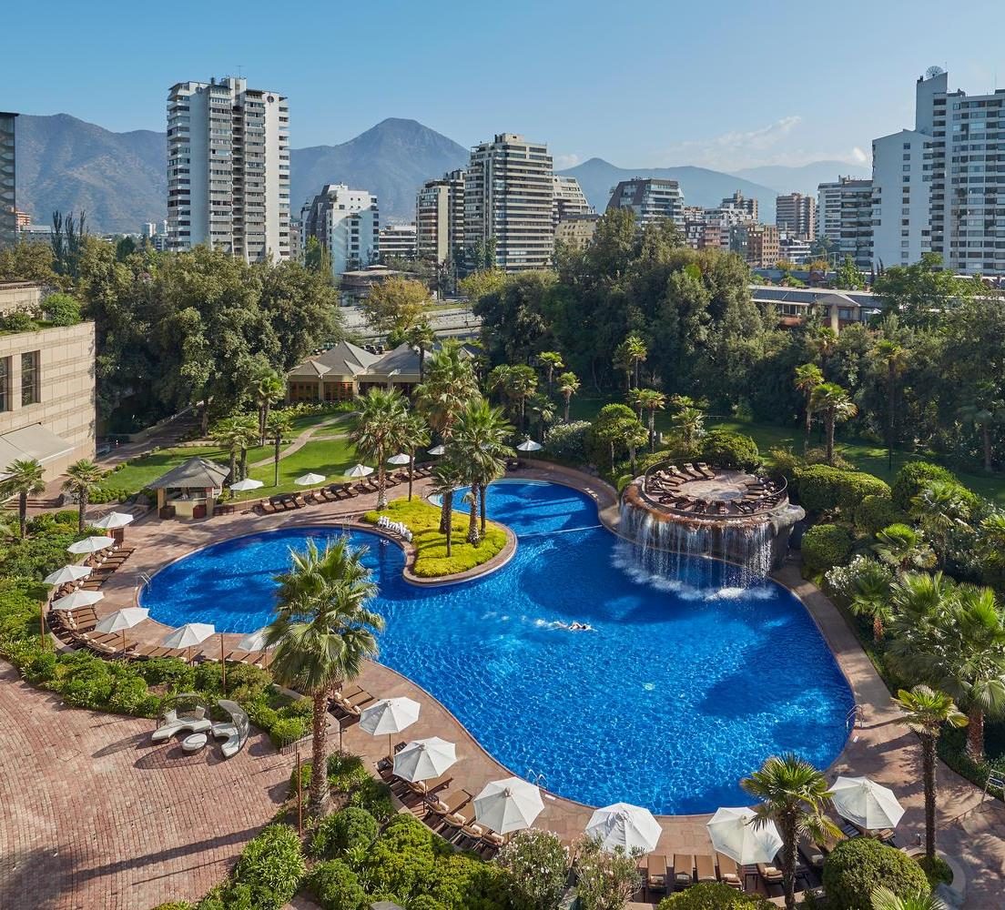 Gardens and pool of the hotel in Santiago, with the Andes behind